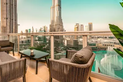 a balcony with chairs and a view of a city at Elite Royal Apartment - Sky Series - Best Burj Khalifa & Fountain View - High Floor - Visionary in Dubai