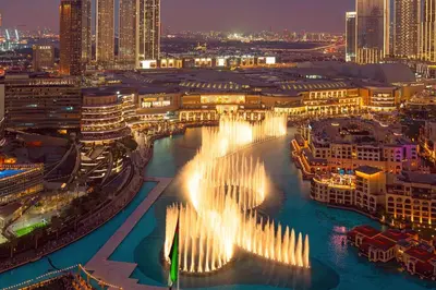 a city with a fountain in the water at night at Elite Royal Apartment - Sky Series - Best Burj Khalifa & Fountain View - High Floor - Visionary in Dubai
