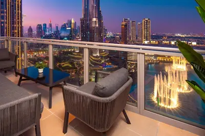 a balcony with a view of a city at night at Elite Royal Apartment - Sky Series - Best Burj Khalifa & Fountain View - High Floor - Visionary in Dubai