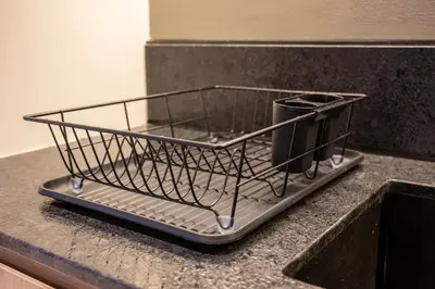 a wire basket sitting on top of a kitchen counter at Brand New Designer Studio - Urban Retreat in JVC in Dubai
