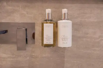 two bottles of essential oils sitting on a table at Brand New Designer Studio - Urban Retreat in JVC in Dubai