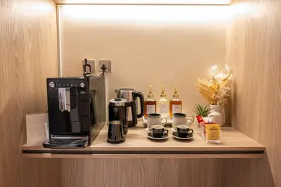 a coffeemaker and coffee maker on a shelf in a hotel room at Brand New Designer Studio - Urban Retreat in JVC in Dubai