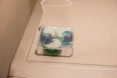 a plastic container filled with beads on top of a counter at Brand New Designer Studio - Urban Retreat in JVC in Dubai
