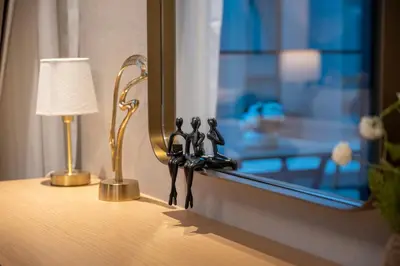 a figurine of people standing on a window sill at Brand New Designer Studio - Urban Retreat in JVC in Dubai