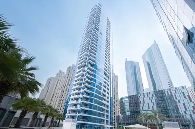 a tall building in the middle of a city at Bright and Modern Condo in Dubai Marina in Dubai