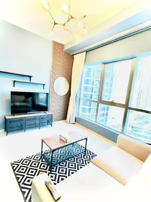 a living room with a couch and a table at Bright and Modern Condo in Dubai Marina in Dubai