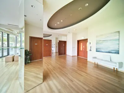 a living room with wooden floors and a large ceiling at Luxury 1BR Downtown Dubai Skyline & Sea View in Dubai
