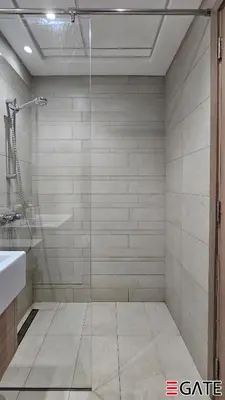 a bathroom with a glass shower and a sink at EGATE - Studio - 2nd Floor with Balcony - Dubai - 33-212 in Dubai