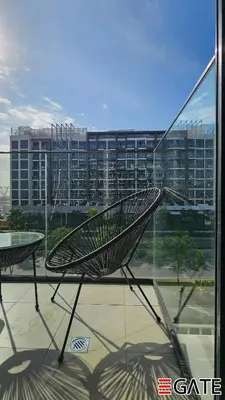 a metal bench sitting in front of a window at EGATE - Studio - 2nd Floor with Balcony - Dubai - 33-212 in Dubai