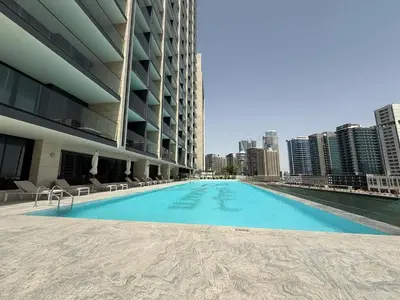 a swimming pool on the roof of a building with a city at Daniels Studio at Marasi Drive with Canal View in Dubai