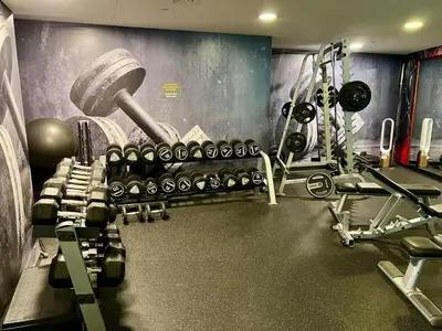 a gym with a bunch of weights and machines at Stylish Apartment - Dubai Marina in Dubai