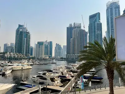 a group of boats docked in a harbor with a city at Stylish Apartment - Dubai Marina in Dubai