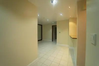 an empty hallway with a tile floor and white walls at Stylish Apartment - Dubai Marina in Dubai
