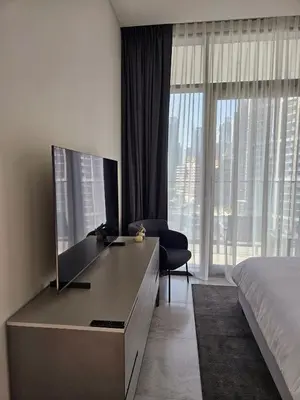 a bedroom with a desk with a tv and a bed at Luxury Fully Furnished One Bedroom in Dubai
