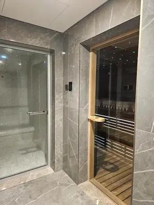 a walkin shower with a glass door in a bathroom at Luxury Fully Furnished One Bedroom in Dubai