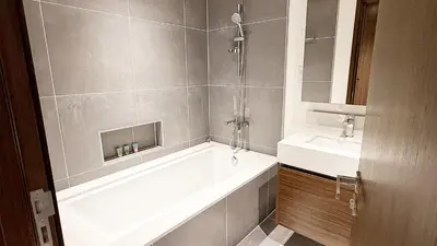 a bathroom with a bath tub and a sink at Luxury 2BHK & Lagoon view in Dubai