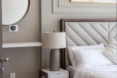 a bedroom with a bed with a lamp and a mirror at Burj Khalifa View - 4 min Dubai Mall - SwimingPool - Business Bay in Dubai