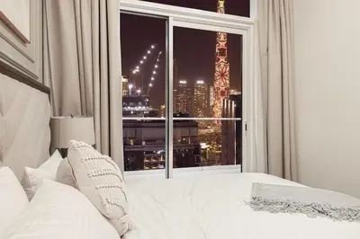 a bedroom with a bed and a window with a view at Burj Khalifa View - 4 min Dubai Mall - SwimingPool - Business Bay in Dubai