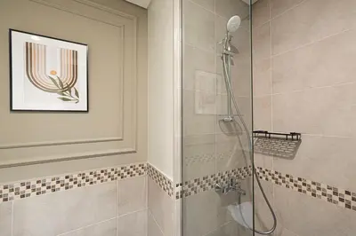 a bathroom with a shower with a glass door at Burj Khalifa View - 4 min Dubai Mall - SwimingPool - Business Bay in Dubai