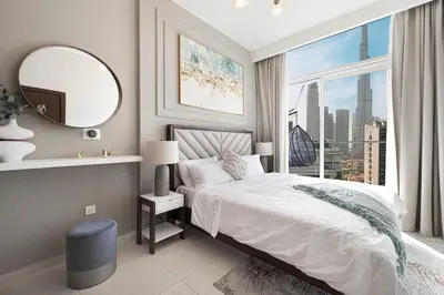 a bedroom with a bed and a mirror and a window at Burj Khalifa View - 4 min Dubai Mall - SwimingPool - Business Bay in Dubai