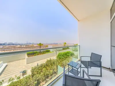 a balcony with chairs and a view of the ocean at TRPS - Carson Tower B, DAMAC Hills - Brand New Luxury Studio Apartment in Dubai