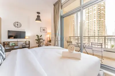 a bedroom with a large white bed and a large window at Downtown Luxury Large Studio Near Burj Khalifa with City Views, - Claren Tower 1, Downtown Dubai by Deluxe Holiday Homes in Dubai