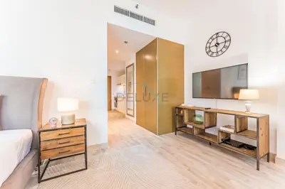 a bedroom with a bed and a dresser and a clock at Downtown Luxury Large Studio Near Burj Khalifa with City Views, - Claren Tower 1, Downtown Dubai by Deluxe Holiday Homes in Dubai