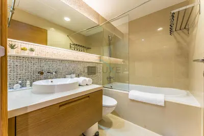a bathroom with a sink and a toilet and a tub at Downtown Luxury Large Studio Near Burj Khalifa with City Views, - Claren Tower 1, Downtown Dubai by Deluxe Holiday Homes in Dubai