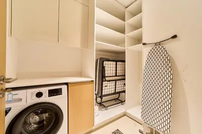a small laundry room with a washer and dryer at Chic 2BR in Mulberry with Dubai Hills Park Views in Dubai