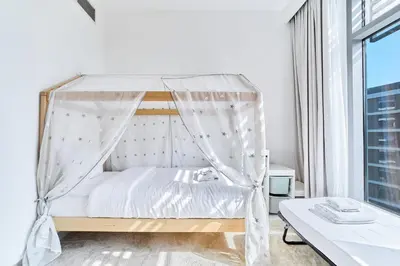 a bedroom with a bed with a canopy at Chic 2BR in Mulberry with Dubai Hills Park Views in Dubai