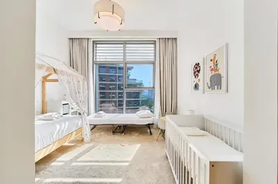 a bedroom with two beds and a window at Chic 2BR in Mulberry with Dubai Hills Park Views in Dubai