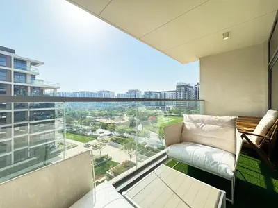 a living room with a view of a city at Chic 2BR in Mulberry with Dubai Hills Park Views in Dubai
