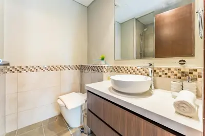 a bathroom with a sink and a toilet at City and Burj Khalifa View 2BR, Near Dubai Water Canal, Vera Tower, Business Bay by Deluxe Holiday Homes in Dubai