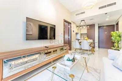 a living room with a large tv on a wall at City and Burj Khalifa View 2BR, Near Dubai Water Canal, Vera Tower, Business Bay by Deluxe Holiday Homes in Dubai