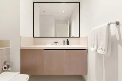 a bathroom with a sink and a mirror at Luxury 3BR Downtown Apt with Burj Khalifa, Dubai Mall & Opera House Views in Dubai