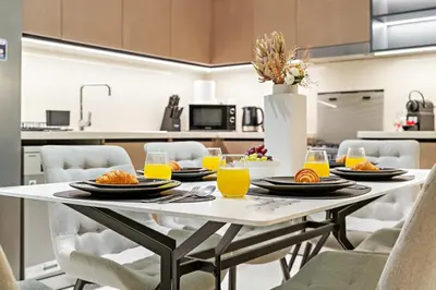 a table with plates of food on it in a kitchen at Luxury 3BR Downtown Apt with Burj Khalifa, Dubai Mall & Opera House Views in Dubai
