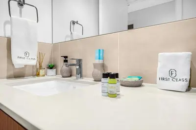 a bathroom counter with a sink and a mirror at Family 2BR Near Creek, Shops, Dining & Top Attractions in Dubai