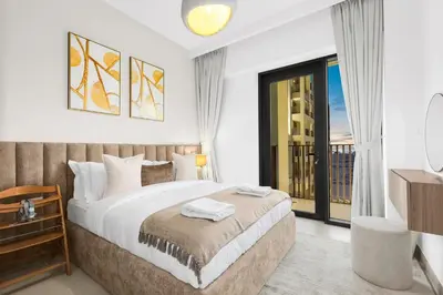a bedroom with a large bed and a balcony at Family 2BR Near Creek, Shops, Dining & Top Attractions in Dubai