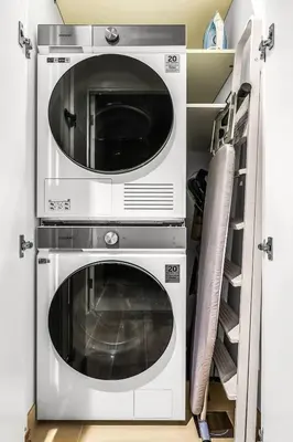 two microwaves stacked on top of each other in a kitchen at Family 2BR Near Creek, Shops, Dining & Top Attractions in Dubai