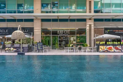 a hotel with a swimming pool in front of a building at 1BR plus Extra Bedroom Bay Square B7, City View in Dubai