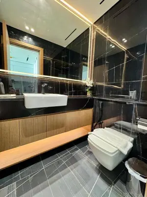 a bathroom with a toilet and a sink at Cozy 1br With Elegant Interiors! in Dubai