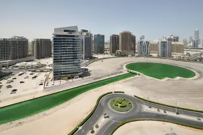 an aerial view of a city with tall buildings at Studio Aura at Dubai Sports City in Dubai