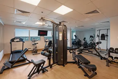 a gym with several treadmills and exercise bikes at Studio Aura at Dubai Sports City in Dubai