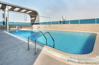 a large swimming pool on a building at Studio Aura at Dubai Sports City in Dubai