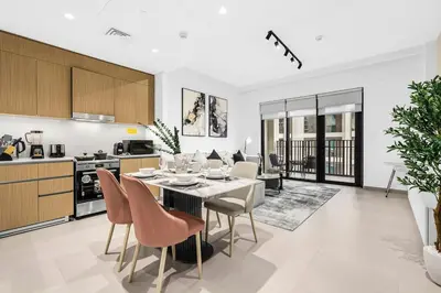 a kitchen and dining room with a table and chairs at FIRST CLASS 2BR Design Meets Comfort in Dubai