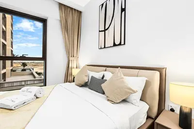 a bedroom with a large bed with a window at FIRST CLASS 2BR Design Meets Comfort in Dubai