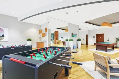 a living room with a pool table and ping pong balls at FIRST CLASS 1BR Majestic Burj Khalifa View in Dubai