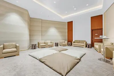 a bedroom with a large bed and chairs at FIRST CLASS 1BR Majestic Burj Khalifa View in Dubai