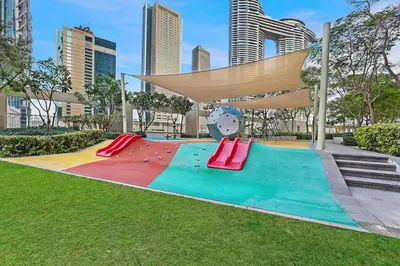a playground in a park with a clock at FIRST CLASS 1BR Majestic Burj Khalifa View in Dubai