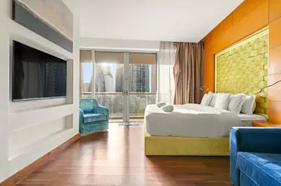 a hotel room with a bed and a tv at FIRST CLASS Studio Stunning Burj Khalifa Views in Dubai